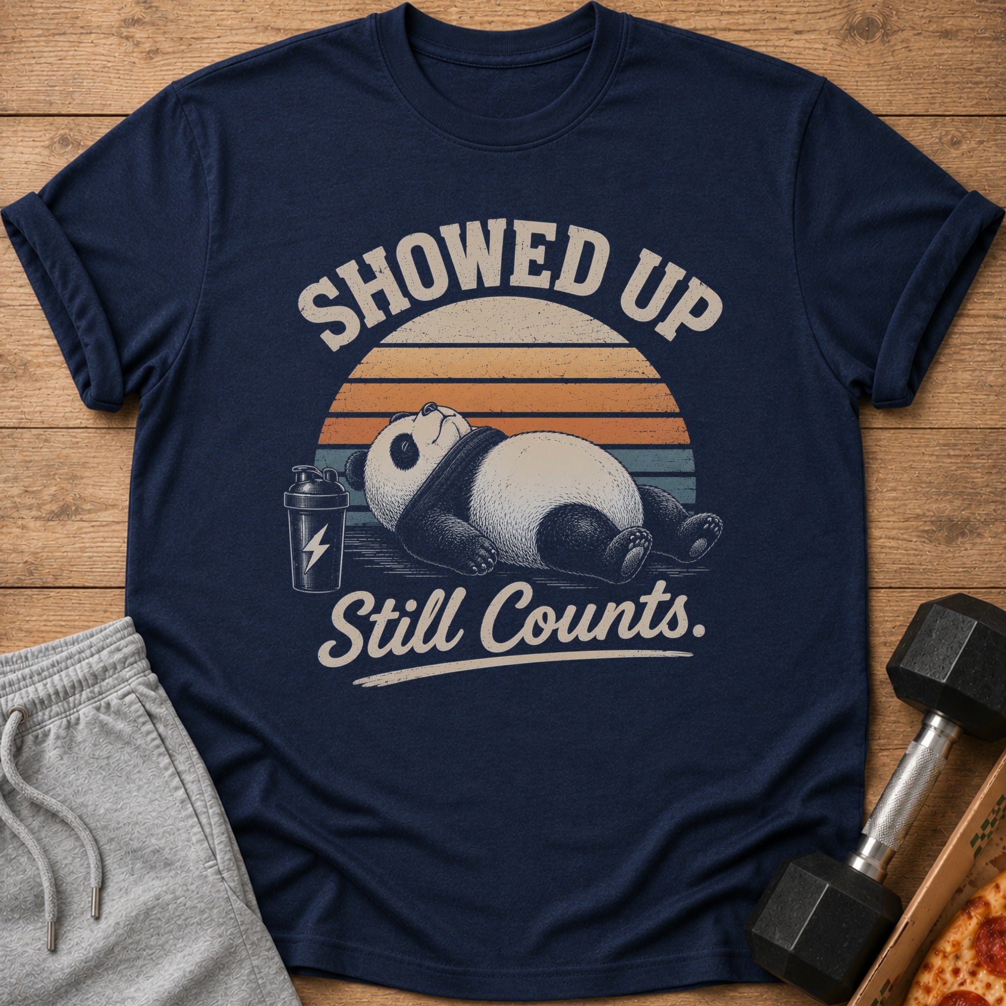 Navy t-shirt with a panda lying down, shaker bottle, and text "Showed up. Still Counts."