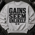 Grey sweatshirt with black distressed text "GAINS SEEM UNLIKELY" and dumbbell graphic.