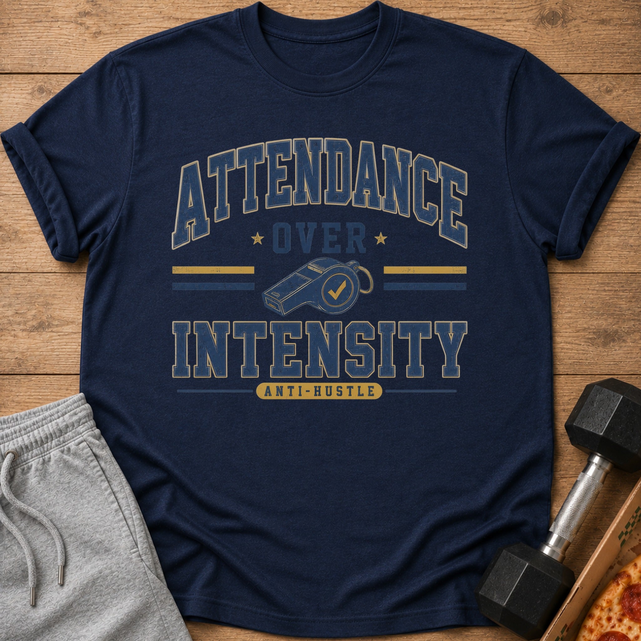 Navy t-shirt with "ATTENDANCE OVER INTENSITY ANTI-HUSTLE" graphic and whistle.