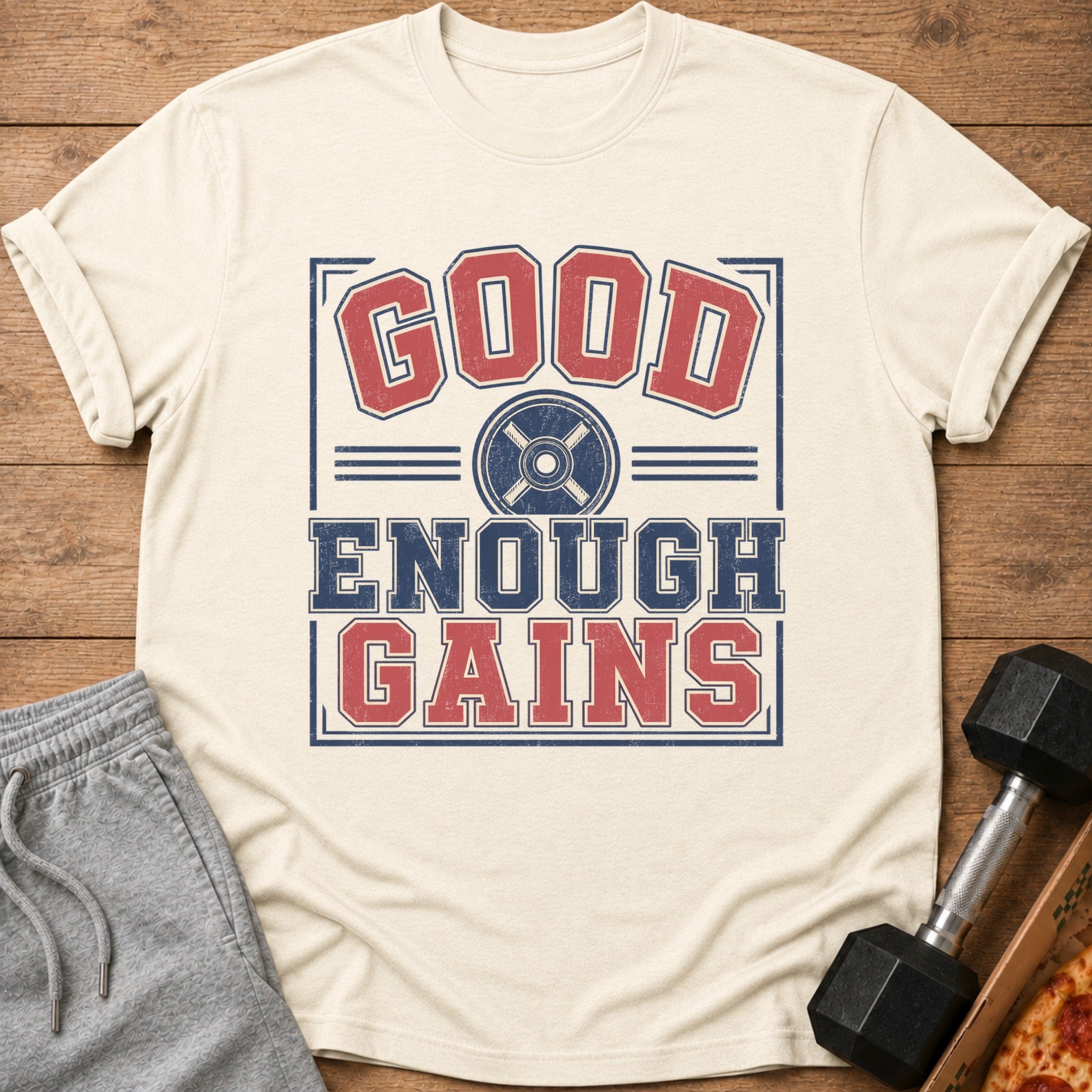 Cream t-shirt with "GOOD ENOUGH GAINS" graphic and weight plate icon.