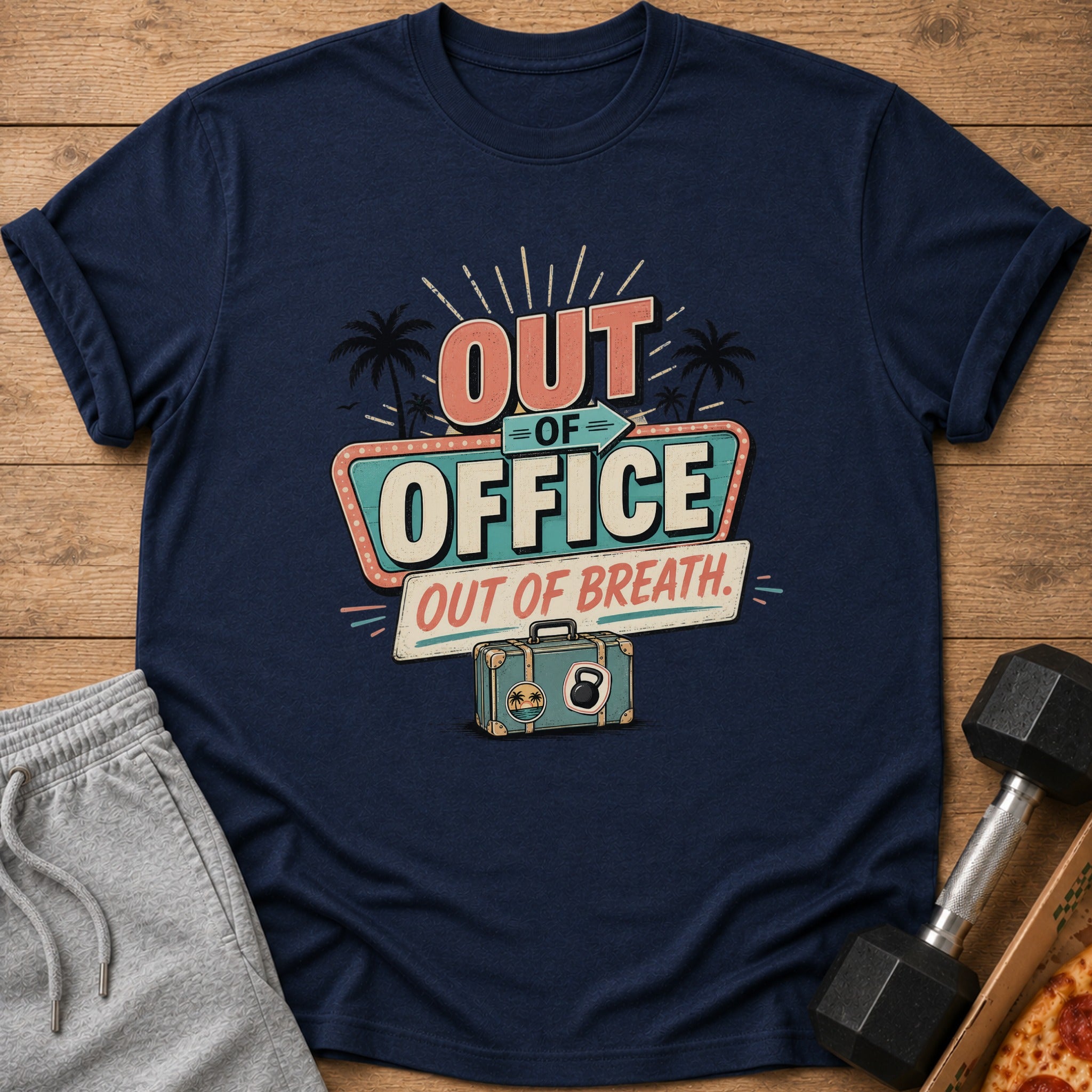 Navy t-shirt with "OUT OF OFFICE, OUT OF BREATH" text, suitcase, and kettlebell graphic.