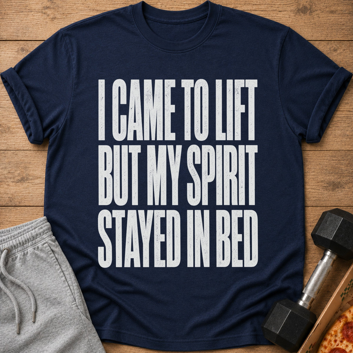 A navy blue t-shirt printed with the white text I CAME TO LIFT BUT MY SPIRIT STAYED IN BED.