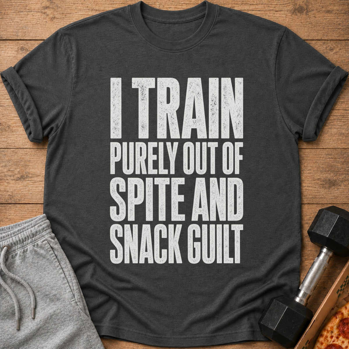 Charcoal t-shirt with white text reading "I TRAIN PURELY OUT OF SPITE AND SNACK GUILT."