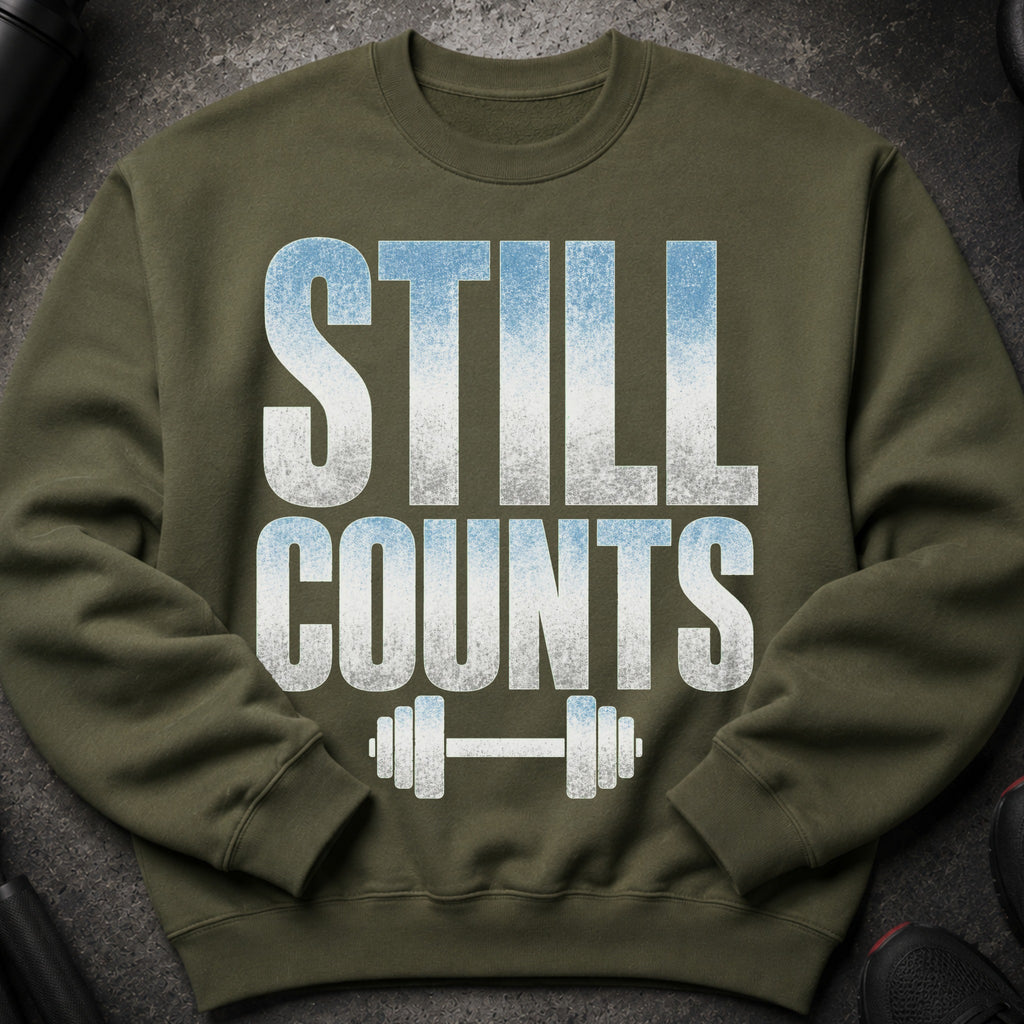 Olive green sweatshirt with "STILL COUNTS" and barbell graphic.