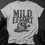 T-shirt graphic: Raccoon lifting dumbbell with text "MILD EFFORT".