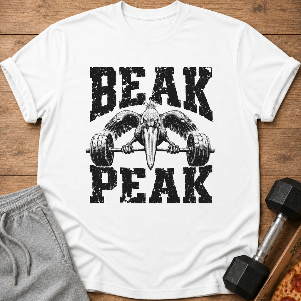 White t-shirt with black distressed graphic of a pelican lifting a barbell, text BEAK PEAK.