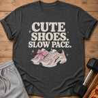 Dark t-shirt with "CUTE SHOES. SLOW PACE." and pink sneakers graphic.