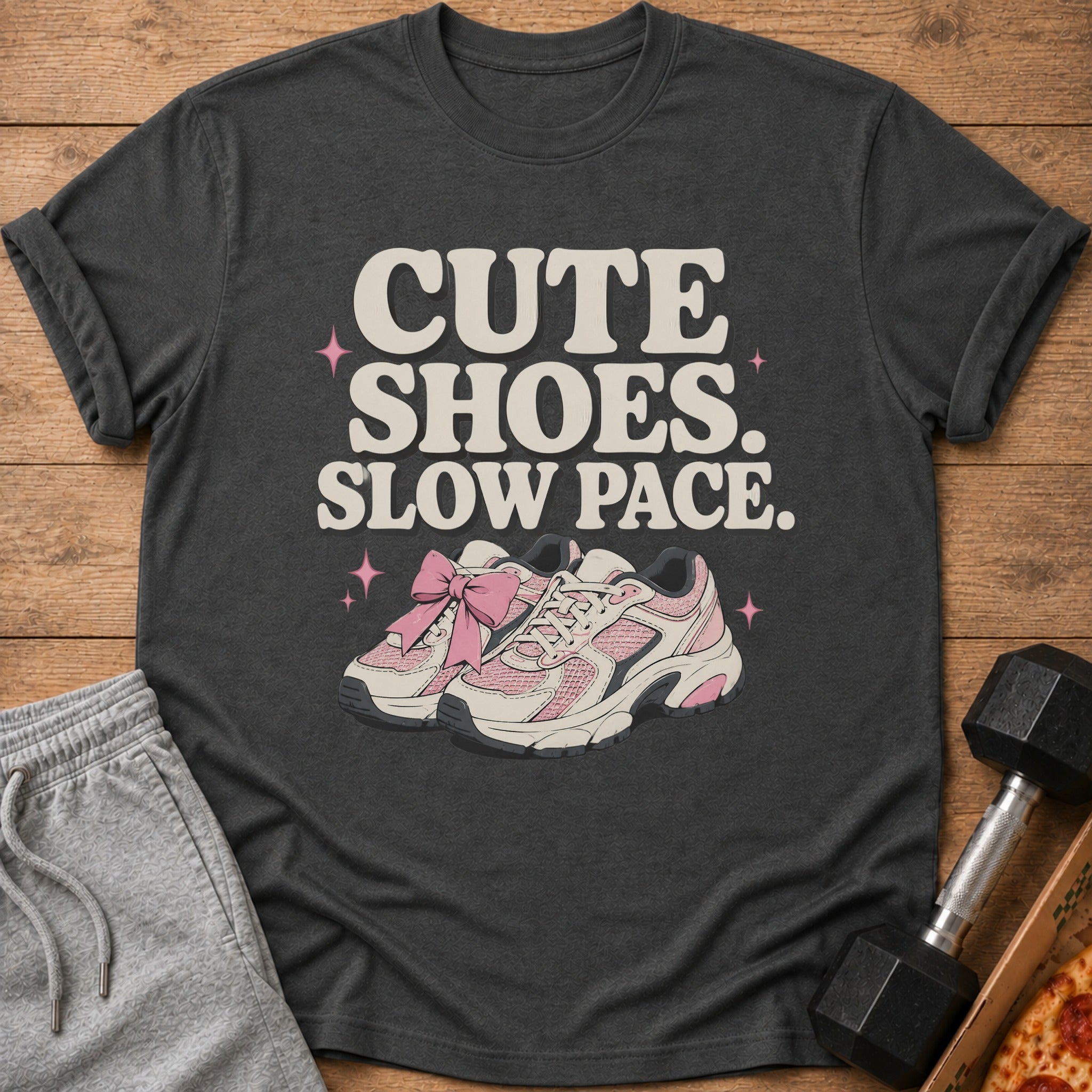 Dark t-shirt with "CUTE SHOES. SLOW PACE." and pink sneakers graphic.