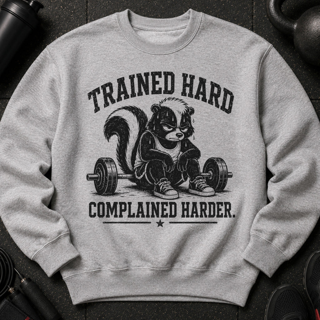Gray sweatshirt with a skunk lifting weights and text "TRAINED HARD COMPLAINED HARDER."
