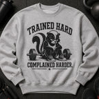 Gray sweatshirt with a skunk lifting weights and text "TRAINED HARD COMPLAINED HARDER."