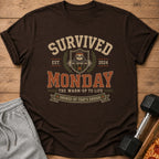 Brown t-shirt with "Survived Monday" text, a sloth lifting weights, and laurel wreaths.