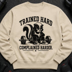 Crewneck sweatshirt with skunk lifting weights and text "TRAINED HARD COMPLAINED HARDER."