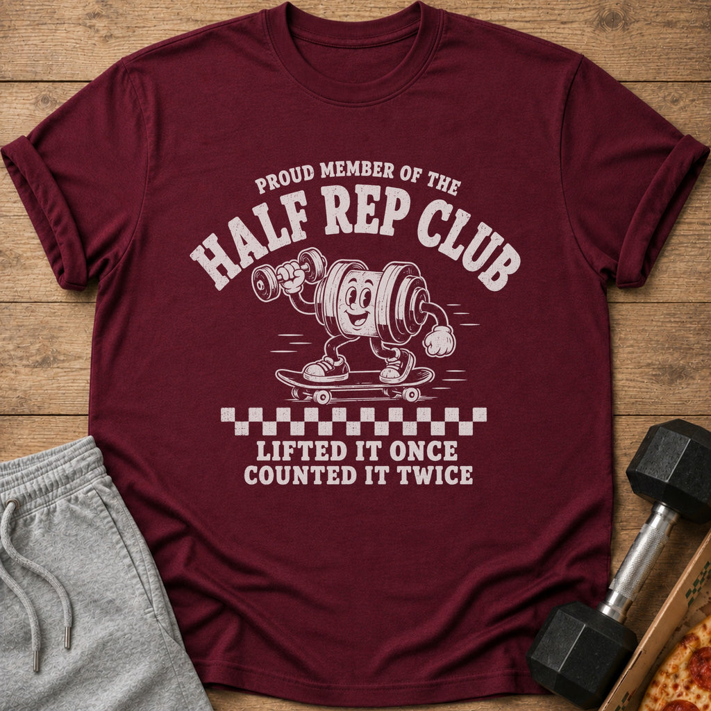 Maroon t-shirt with "Proud Member of the Half Rep Club. Lifted it once counted it twice." graphic.