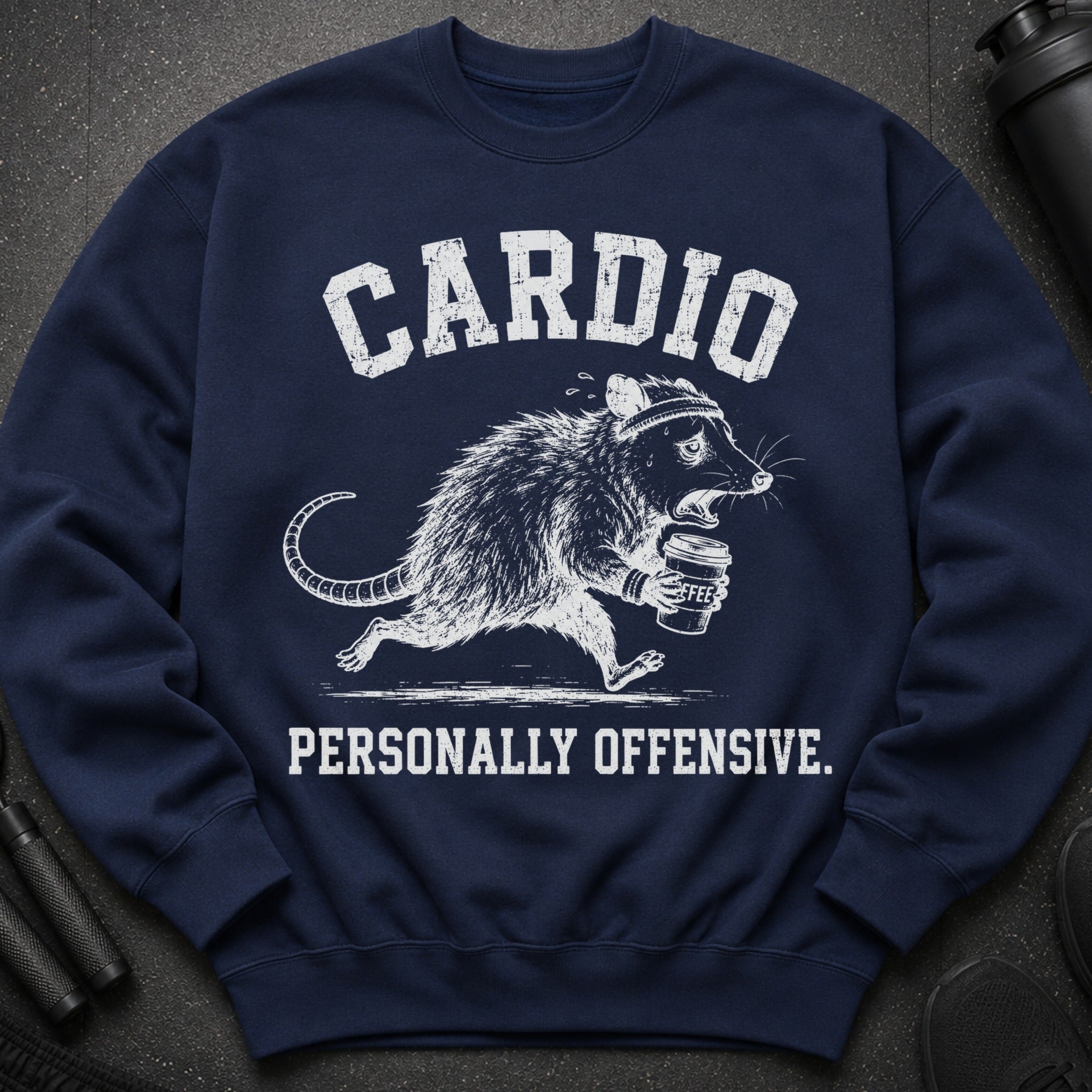 Navy sweatshirt with white distressed text "CARDIO" and a running possum holding coffee.
