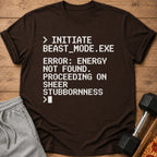 Brown t-shirt with white pixelated text: "Initiate beast_mode.exe Error: energy not found. Proceeding on sheer stubbornness"