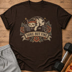 Brown t-shirt with distressed cat on dumbbell design and "Sore But Fine" text.