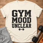 Cream t-shirt with distressed black text "GYM MOOD UNCLEAR" and dumbbell graphic.