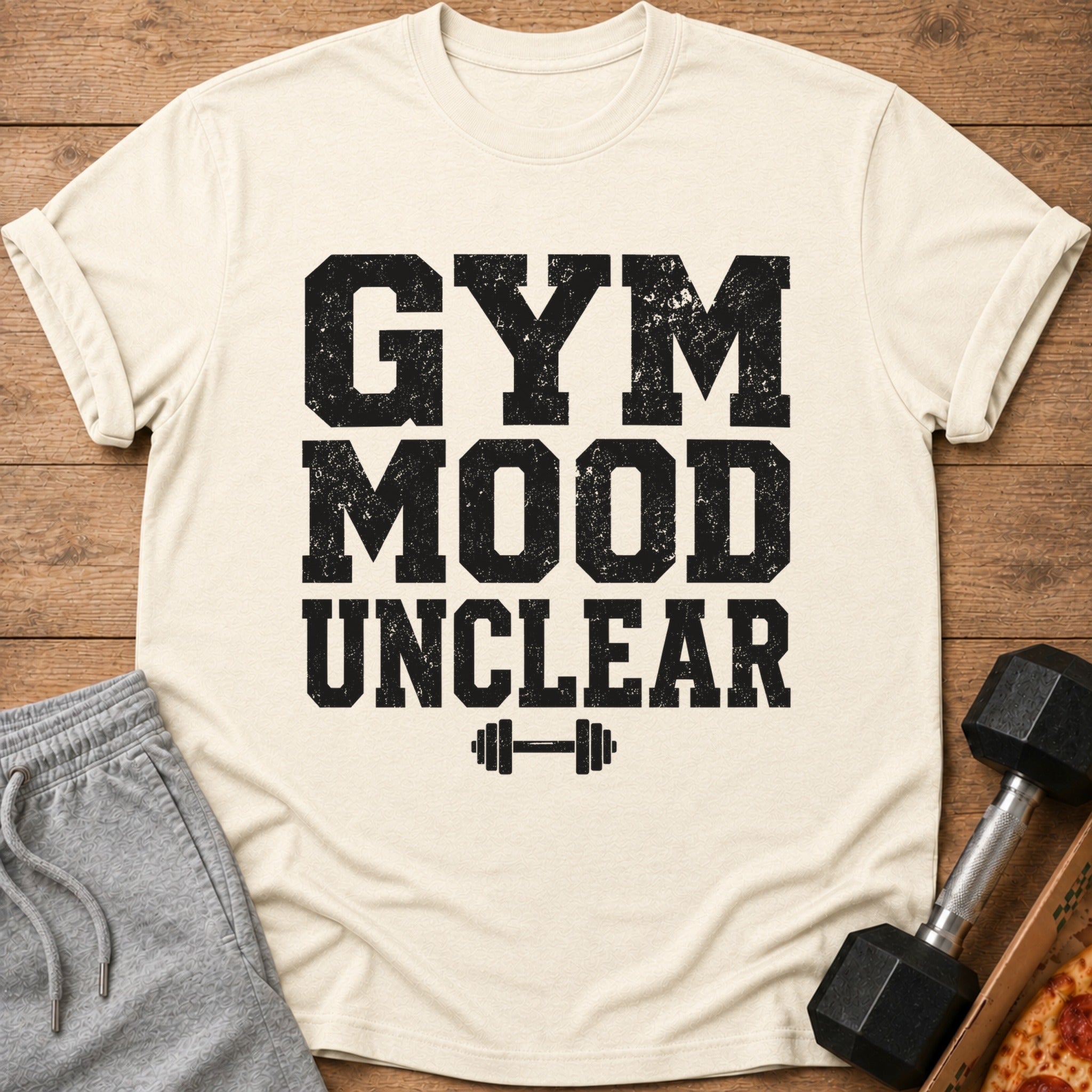 Cream t-shirt with distressed black text "GYM MOOD UNCLEAR" and dumbbell graphic.