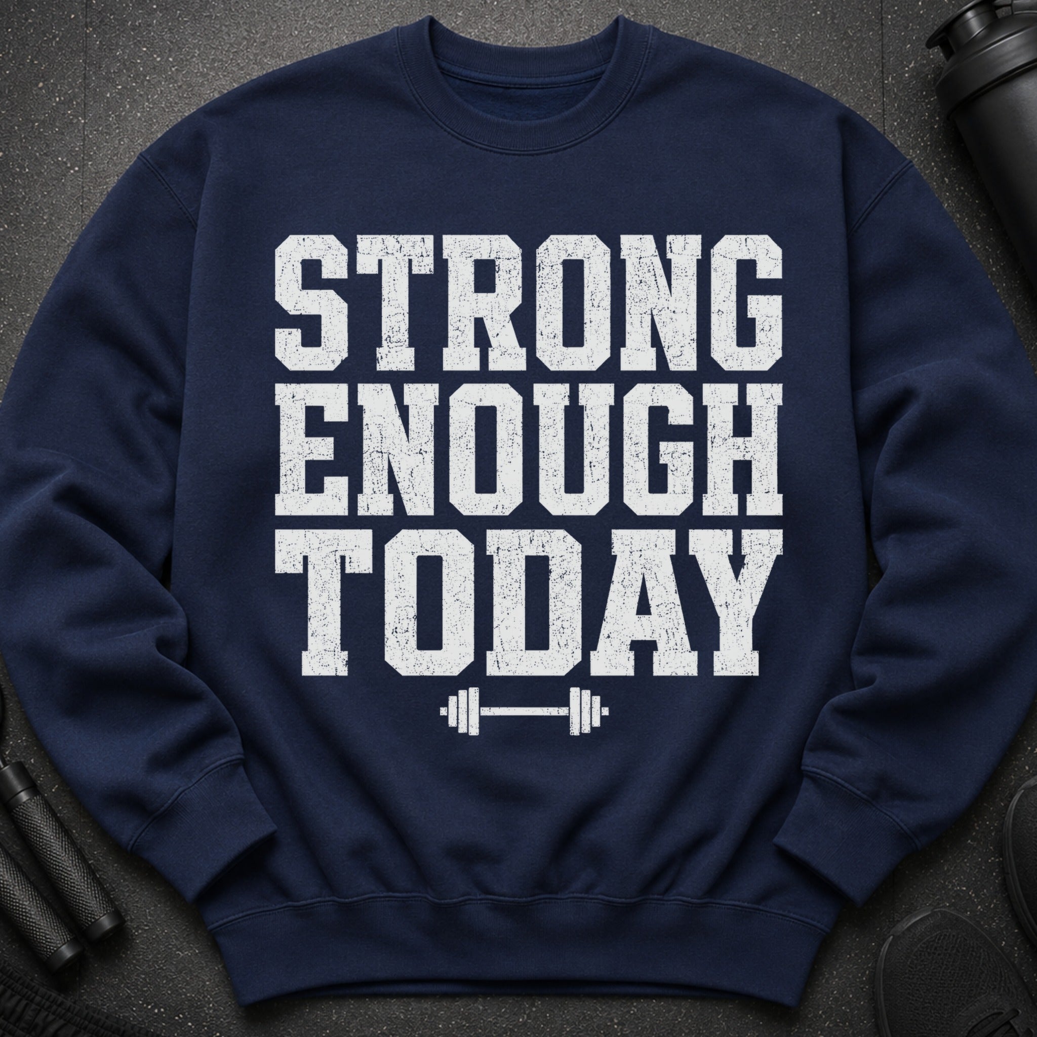 Navy sweatshirt with distressed white text "STRONG ENOUGH TODAY" and dumbbell graphic.