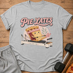 "Pie-Lates" graphic on a grey t-shirt with a pie character exercising.