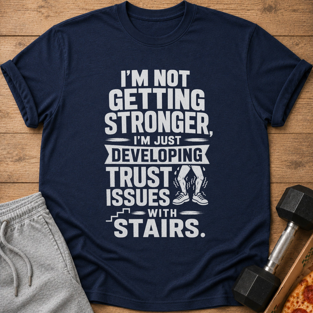 Navy t-shirt with white text: "I'm not getting stronger, I'm just developing trust issues with stairs."