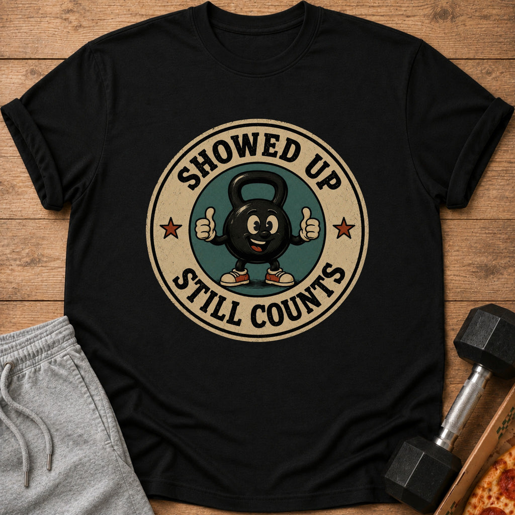 Black t-shirt with a cartoon kettlebell giving a thumbs up and text "Showed up still counts."