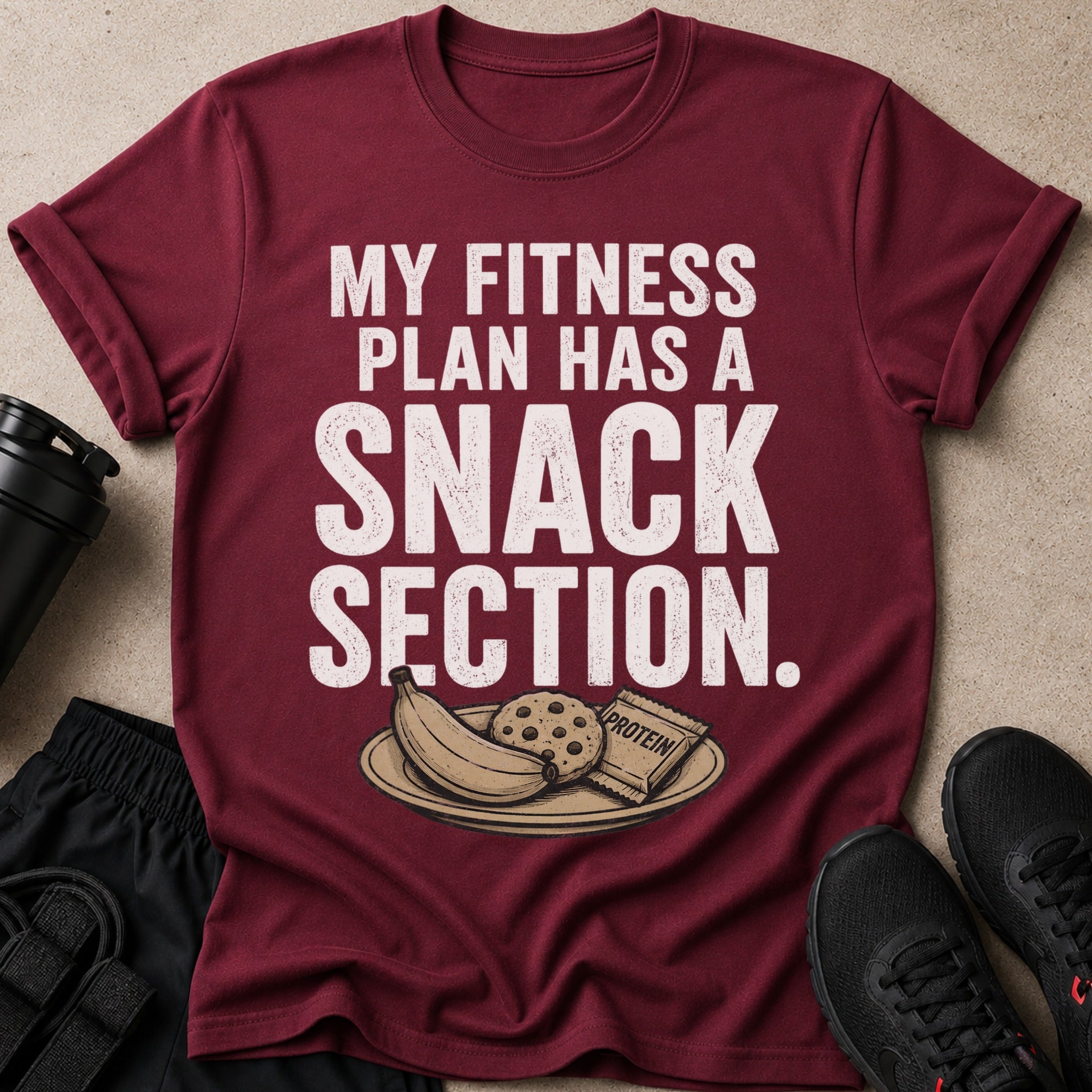 Maroon t-shirt with "My Fitness Plan Has A Snack Section" text and snacks.