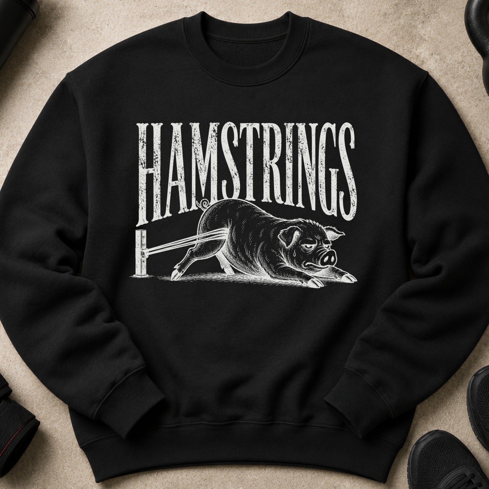 Black sweatshirt with distressed white text "HAMSTRINGS" and a pig design.