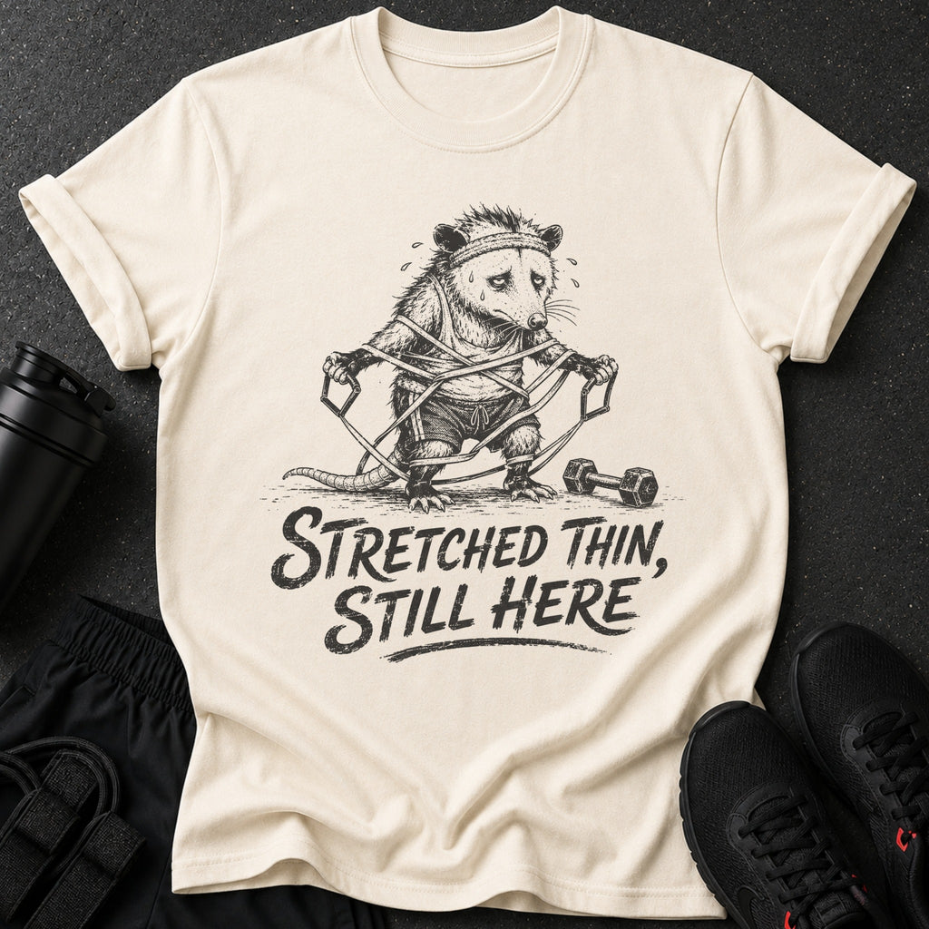 Cream t-shirt with opossum workout graphic and "Stretched Thin, Still Here" text.