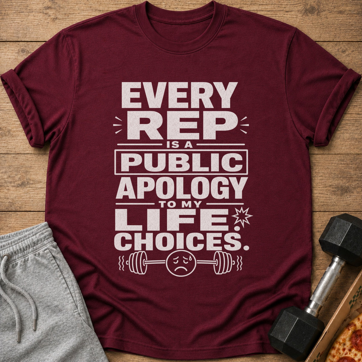 Maroon t-shirt with white text reading "Every Rep Is A Public Apology To My Life Choices."