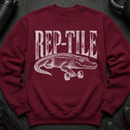 Crewneck sweatshirt with white "REP-TILE" text and alligator lifting a dumbbell.