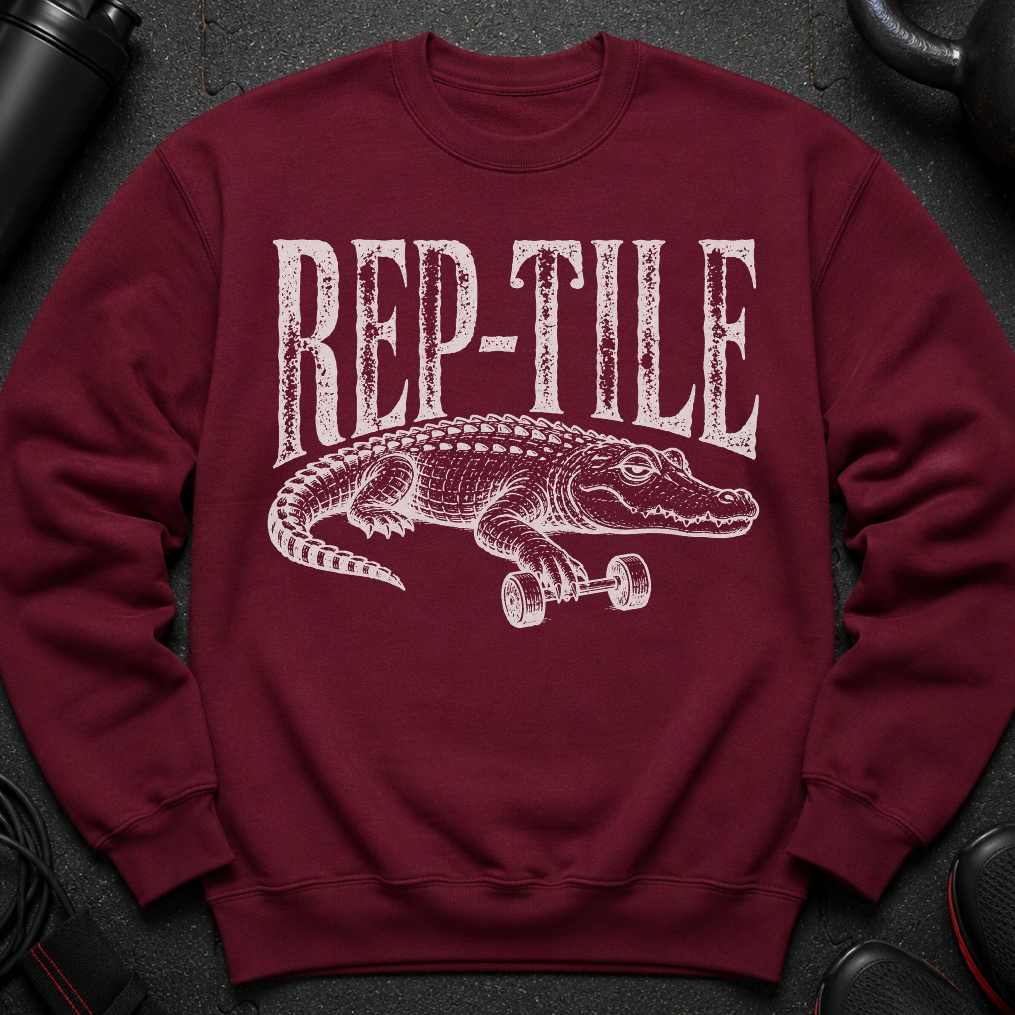 Crewneck sweatshirt with white "REP-TILE" text and alligator lifting a dumbbell.