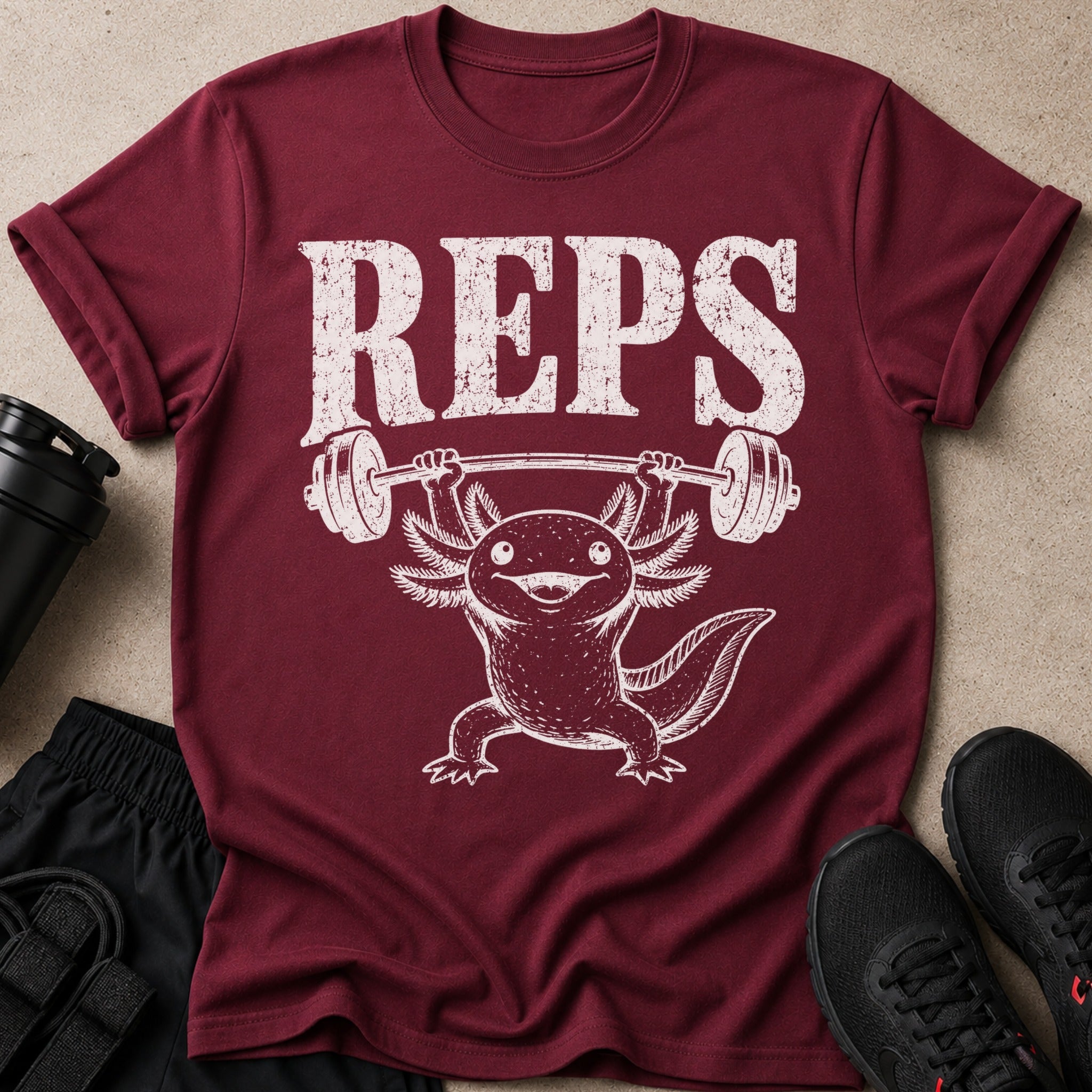 Burgundy t-shirt with white distressed text "REPS" and an axolotl lifting a barbell.