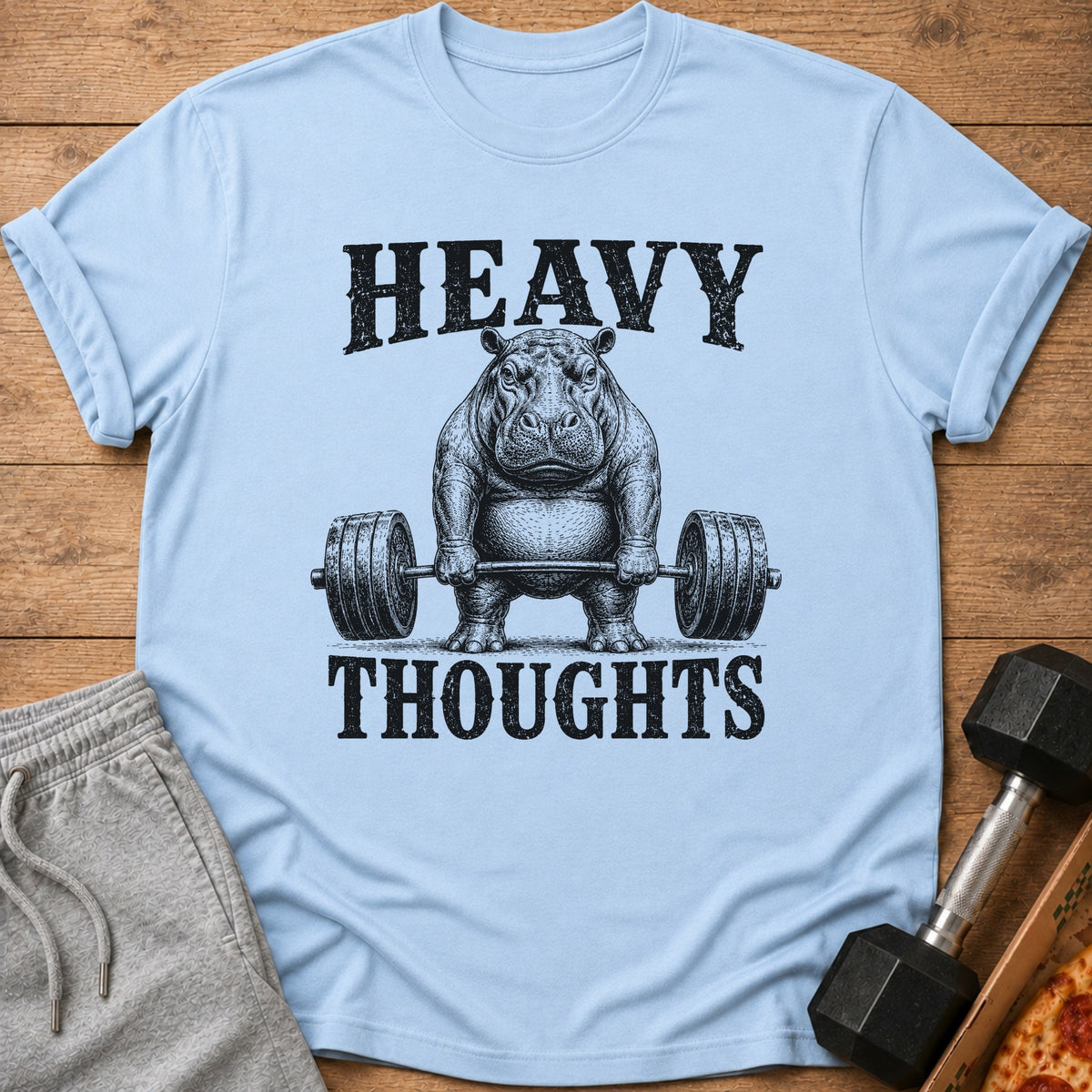 Light blue t-shirt with a hippo lifting weights and text "HEAVY THOUGHTS".