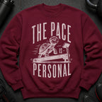 Maroon sweatshirt with distressed graphic of a turtle on a treadmill and text "THE PACE IS PERSONAL".