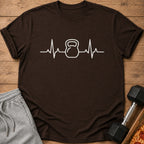 Brown t-shirt with white kettlebell heartbeat graphic and grey sweatpants.
