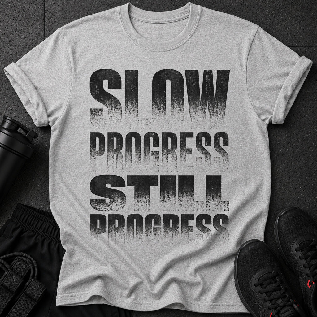 Gray t-shirt with "SLOW PROGRESS STILL PROGRESS" text in distressed black font.
