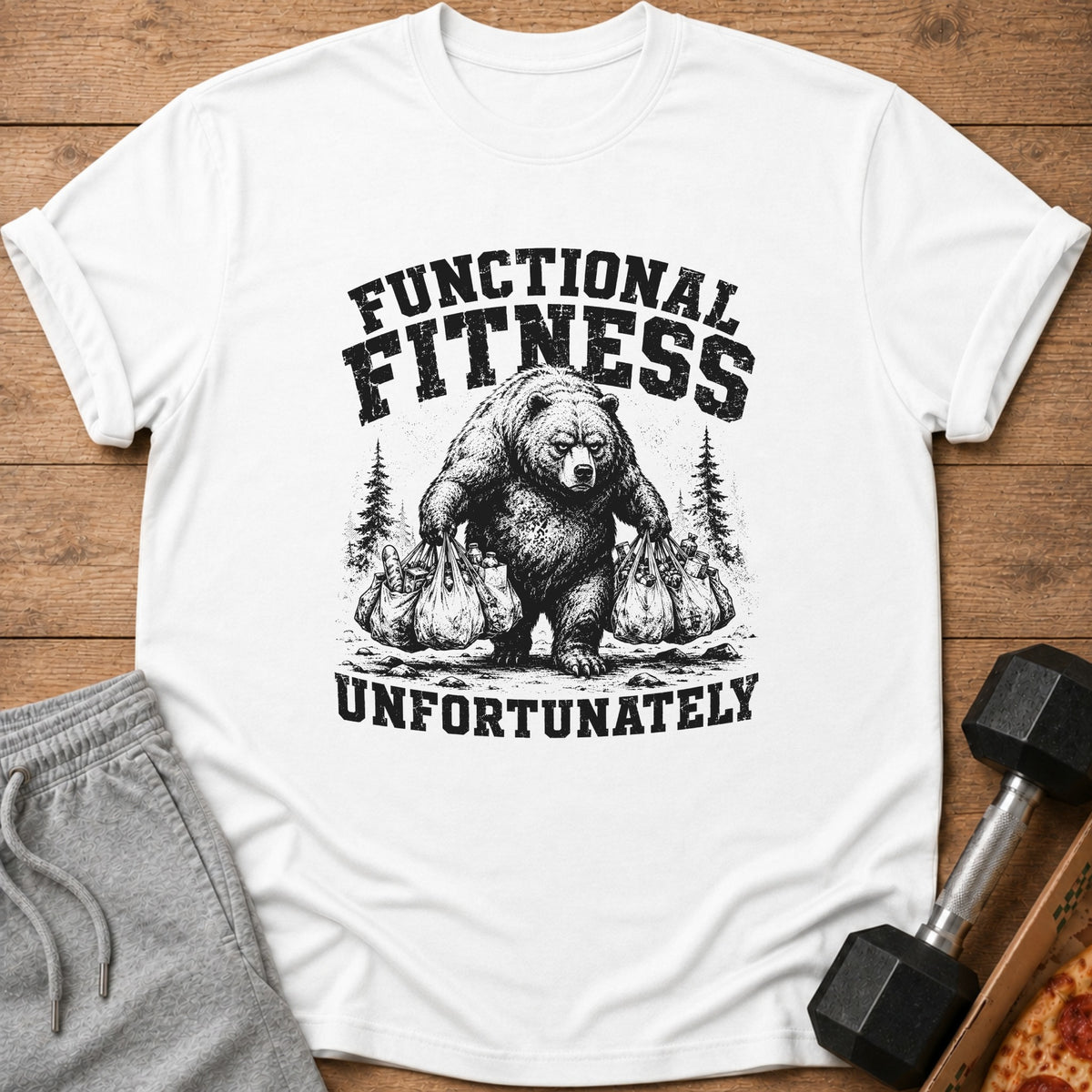 White t-shirt with black graphic of bear carrying groceries, text "FUNCTIONAL FITNESS" and "UNFORTUNATELY".