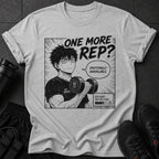 Gray t-shirt with anime-style graphic of a man lifting weights, text says "ONE MORE REP?"