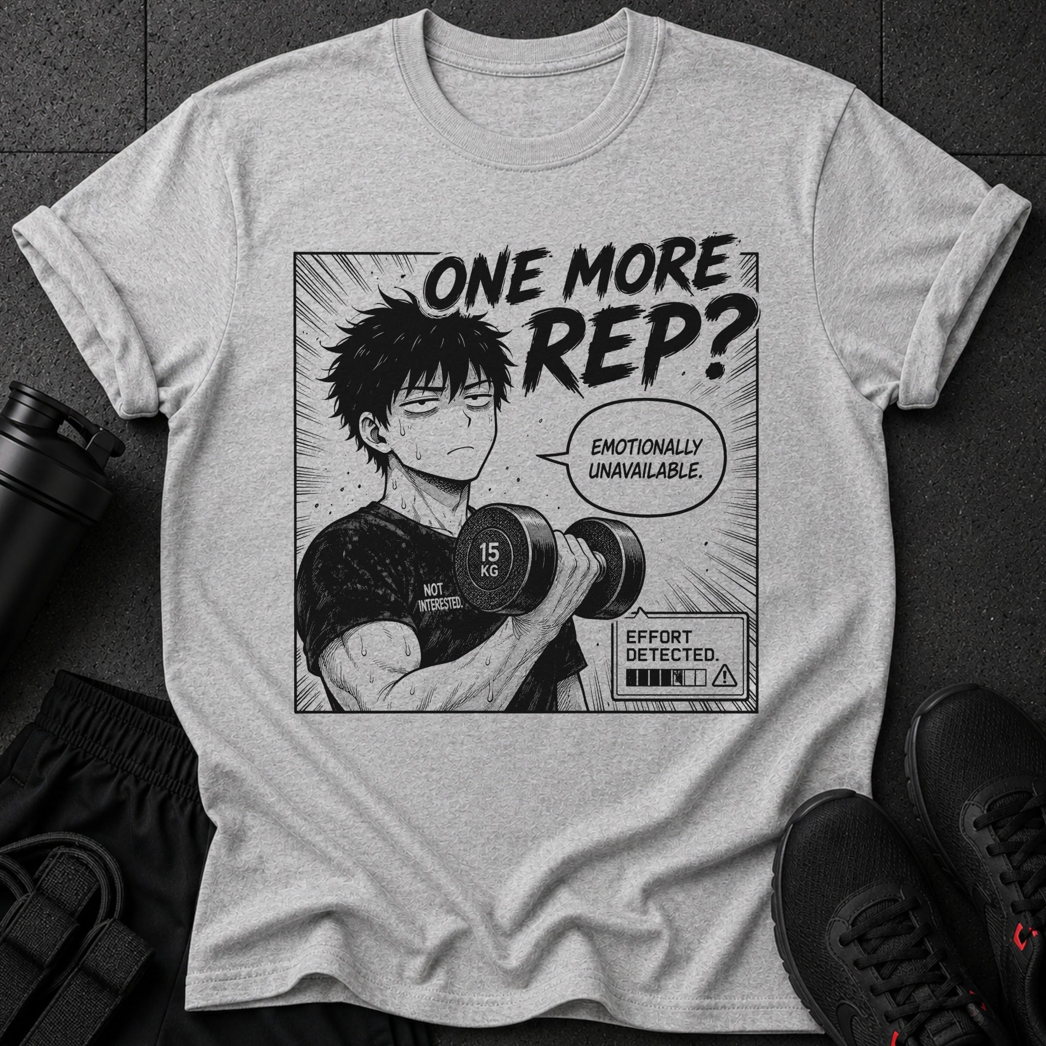 Gray t-shirt with anime-style graphic of a man lifting weights, text says "ONE MORE REP?"