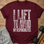 Maroon t-shirt with white distressed text reading "I LIFT TO AVOID MY RESPONSIBILITIES".