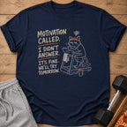 Navy t-shirt with a graphic of a cat on a treadmill and text "Motivation called. I didn't answer."