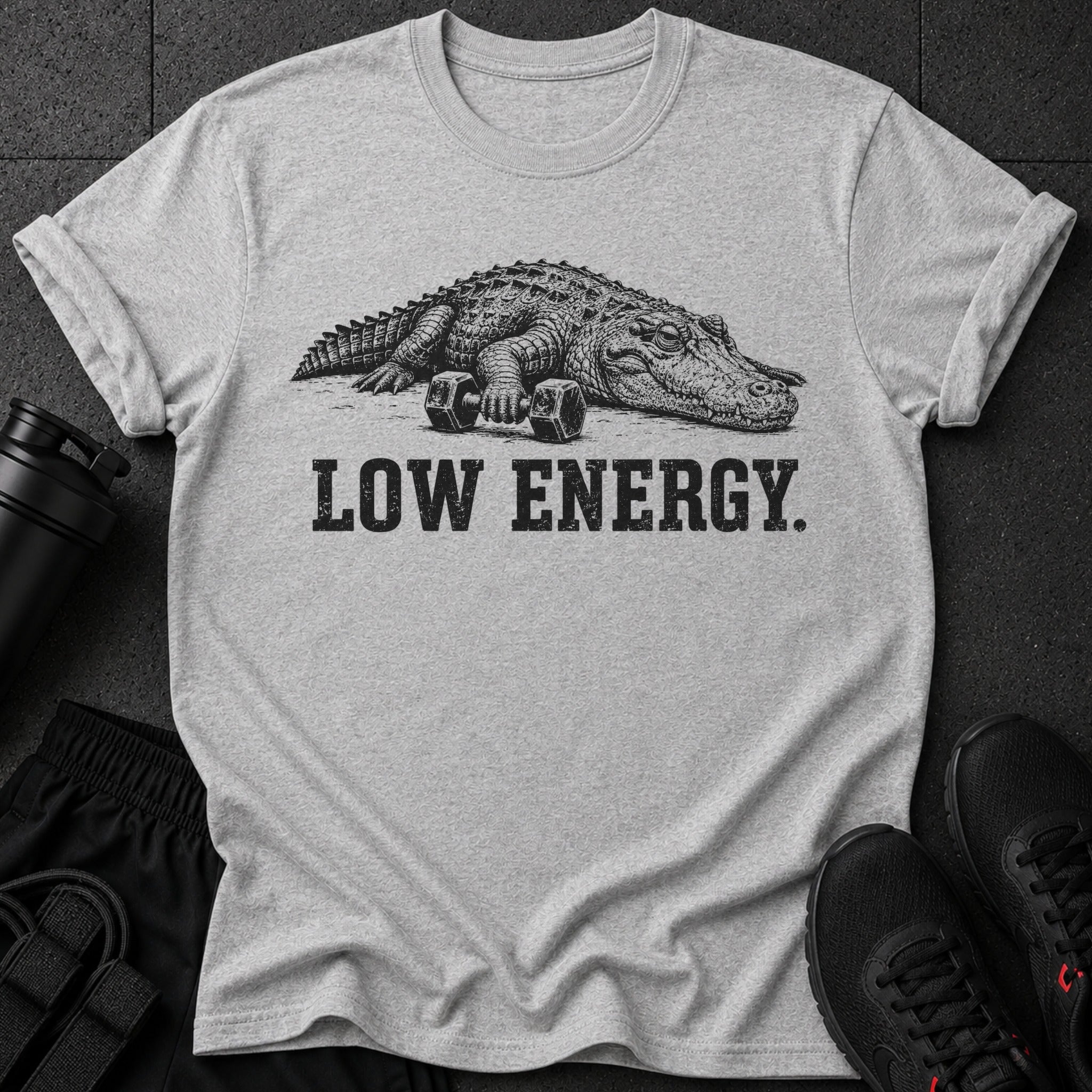 Grey t-shirt with a graphic of an alligator holding dumbbells and text "LOW ENERGY."