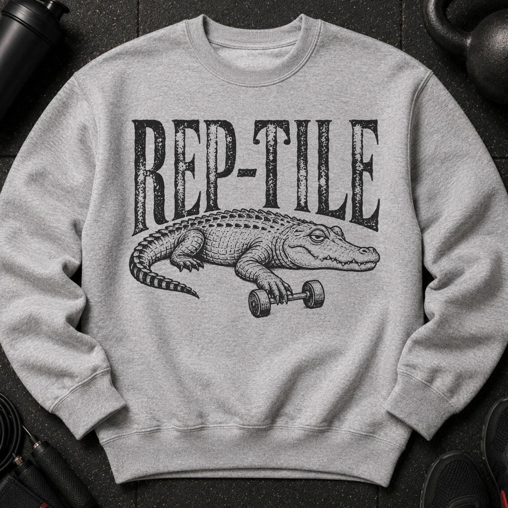Grey sweatshirt with black "REP-TILE" text and alligator lifting dumbbell graphic.