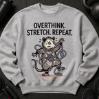Gray sweatshirt with illustration of opossum tangled in rope and text "overthink. stretch. repeat."