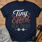 Navy t-shirt with "Tiny Effort, Real Credit" text and dumbbell graphic.