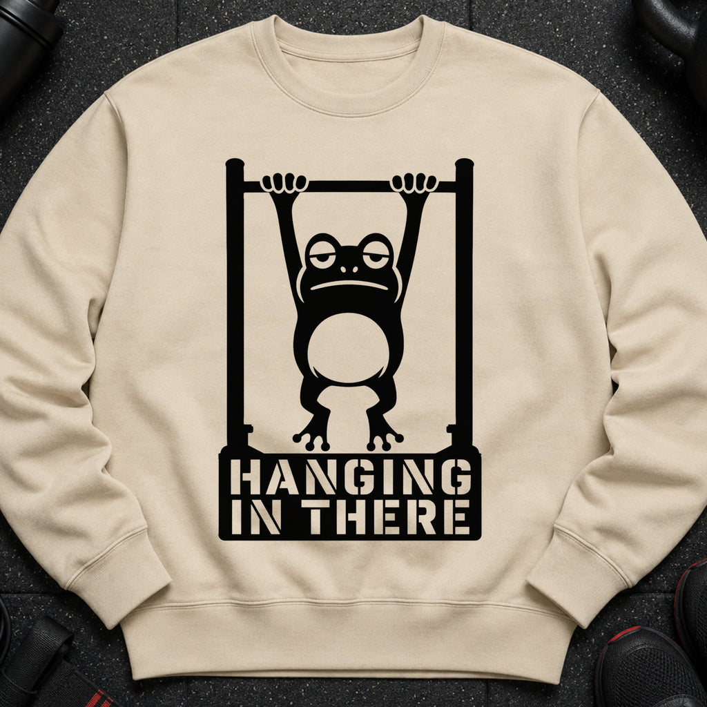 Tired frog hanging from a bar with "HANGING IN THERE" text.