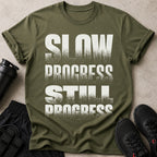 Green t-shirt with white text "SLOW PROGRESS STILL PROGRESS"