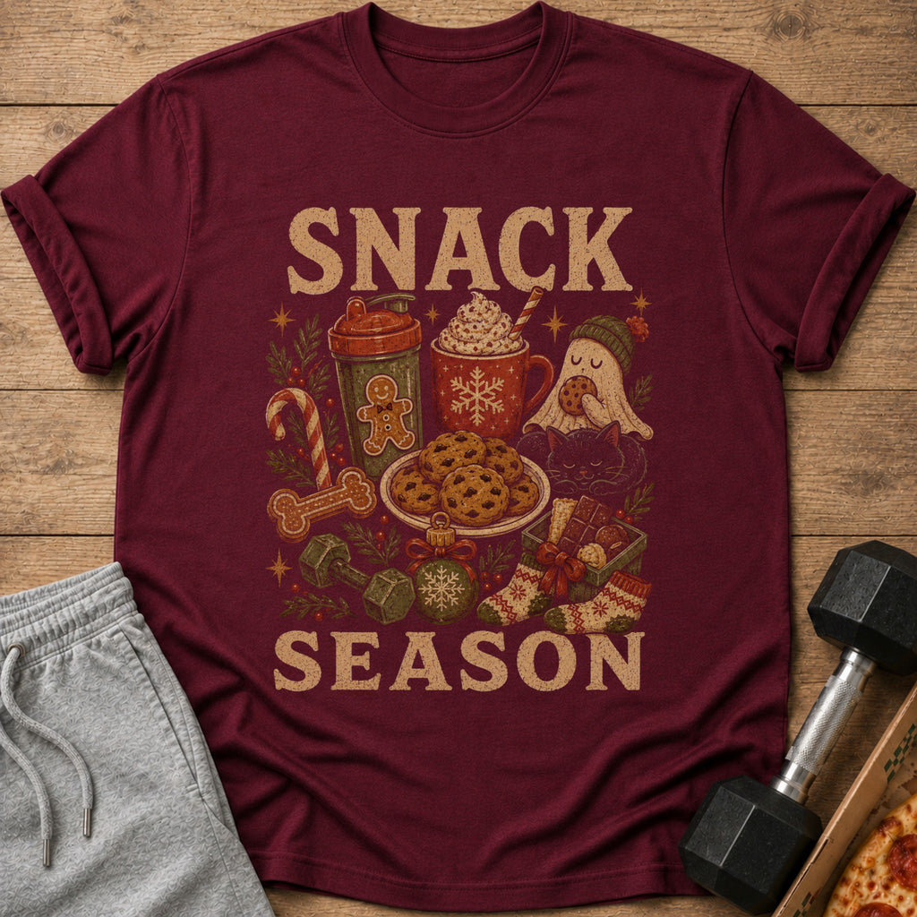 Maroon t-shirt with "SNACK SEASON" text and holiday-themed snack and fitness graphics.