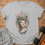 Grey t-shirt with a statue bust, flowers, and dumbbells on the front.